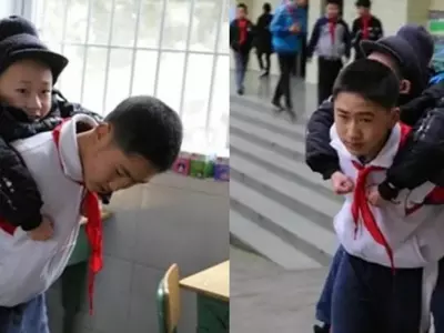 China Boy Carries Friend To School