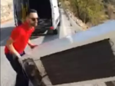 man throw fridge from cliff