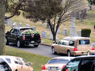 A hearse carrying Whitney Houston's body arrives