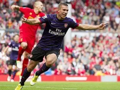 Podolski on target as Arsenal cruise past Liverpool