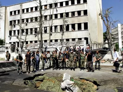 Explosions strike Syrian army building