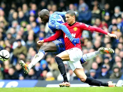 Manchester United's English defender Chris Smalling (R) vies with Chelsea's Senegalese striker Demba Ba (L)