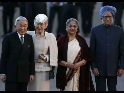 Japan's Emperor Akihito Empress Michiko Indian Prime Minister Manmohan Singh and his wife Gursharan Kaur pose for photographers after the Emperor Akihito's arrival at the airport in New Delhi