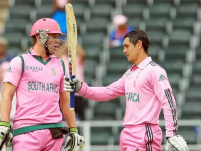 Quinton de Kock, raises his bat after reaching a century as captain Abraham Benjamin de Villiers, left, watches during their 1st One Day International cricket match against India at Wanderers stadium in Johannesburg, South Africa. (Photo: AP)