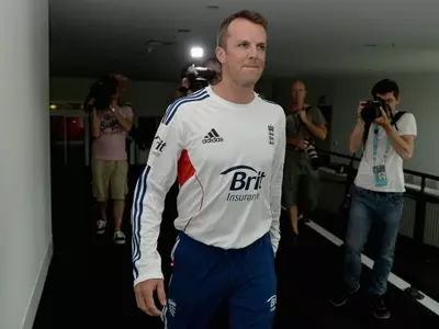 Graeme Swann arrives at a press conference where he announced his retirement.