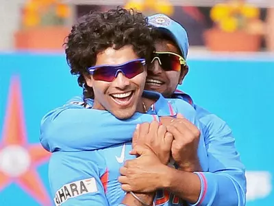 India's R Jadeja celebrates with Suresh Raina after dismissing England batsman JW Dernbatch