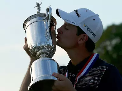 England's Justin Rose kisses the U.S. Open Trophy after winning the 2013 U.S. Open golf championship in Ardmore
