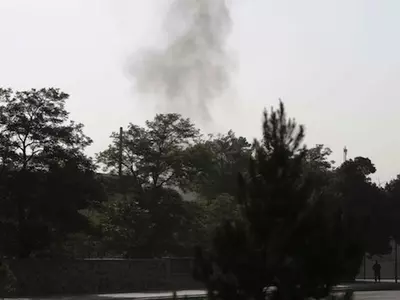 Smoke rises from the eastern gate of the presidential palace in Kabul, Afghanistan, Tuesday June 25, 2013. The Taliban said they have hit one of the most secure areas of the Afghan capital with a suicide attack, as a series of explosions rocked the gate l