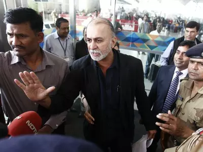 Tarun Tejpal speaks with the media upon his arrival at the airport on his way to Goa, in New Delhi