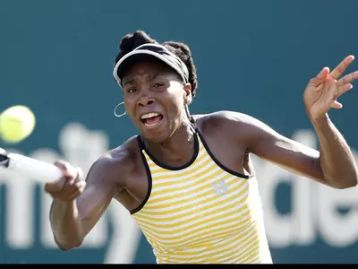 Venus Williams of the US returns to Chanelle Scheepers of South Africa during the WTA Family Circle Cup tournament in Charleston.