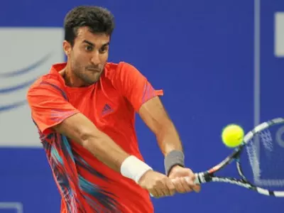 Yuki Bhambri became only the third Indian to reach the singles quarterfinals of an ATP World Tour event at home, after winning his second round against an unfit world number 16 Fabio Fognini, on Thursday.