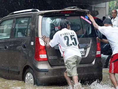 People Push Car in Flood