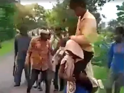 woman forced to carry husband on shoulders