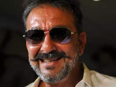 A still of Sanjay Dutt smiling in salt-and-pepper look.