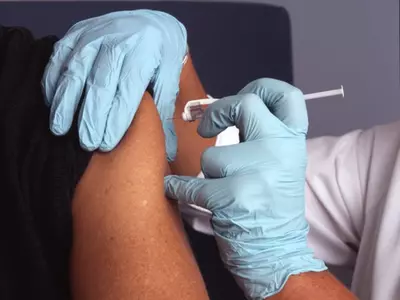 nurse injecting a person 