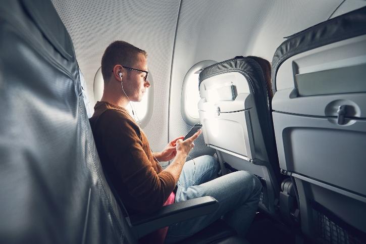 Passenger using the phone on a flight. 