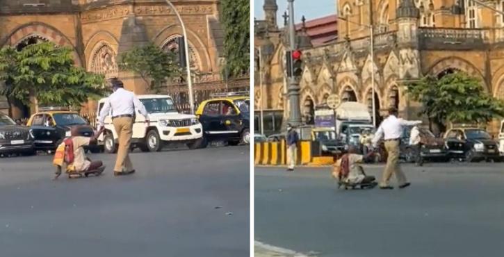 Traffic cop helps differently-abled man cross a busy road. 