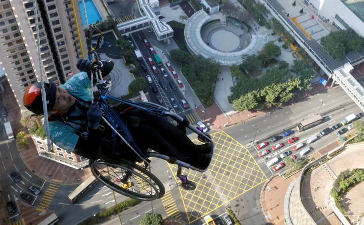Hong Kong wheelchair climber Lai Chi-wai attempts to scale 320-meter skyscraper