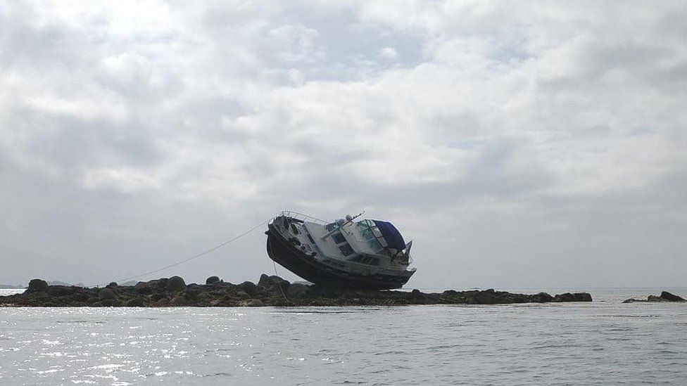 Boat Is Left Perched On Rocks After Running Aground