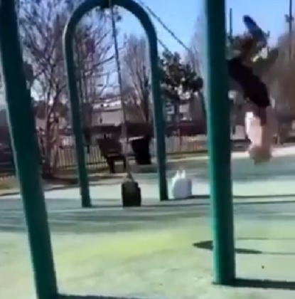 Elderly man performs stunt on swing set