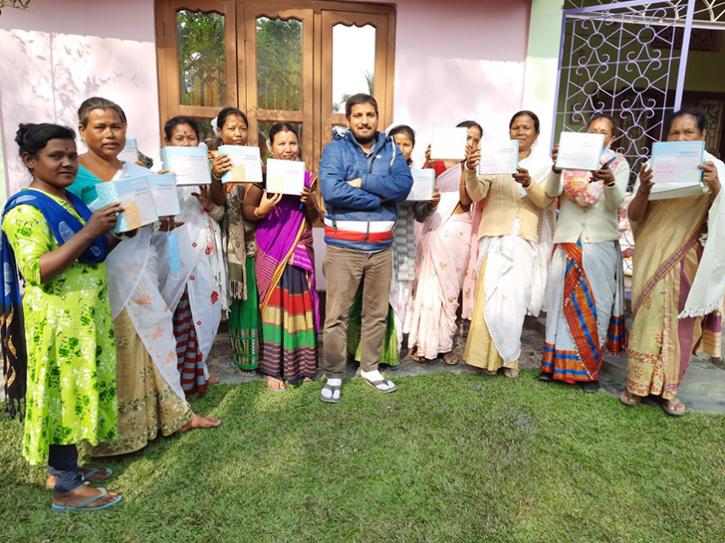 Upamanyu Borkakoty (centre, in blue) with the all-female workforce holding up TRUEDIPS boxes