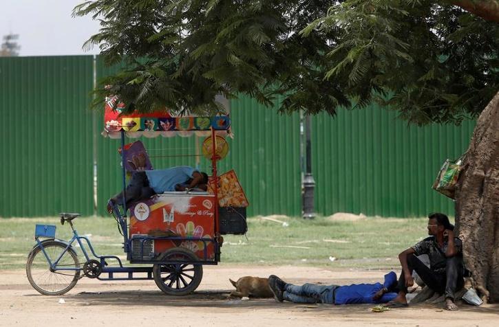 A vendor rests on his ice cream cart on a hot summer day in New Delhi