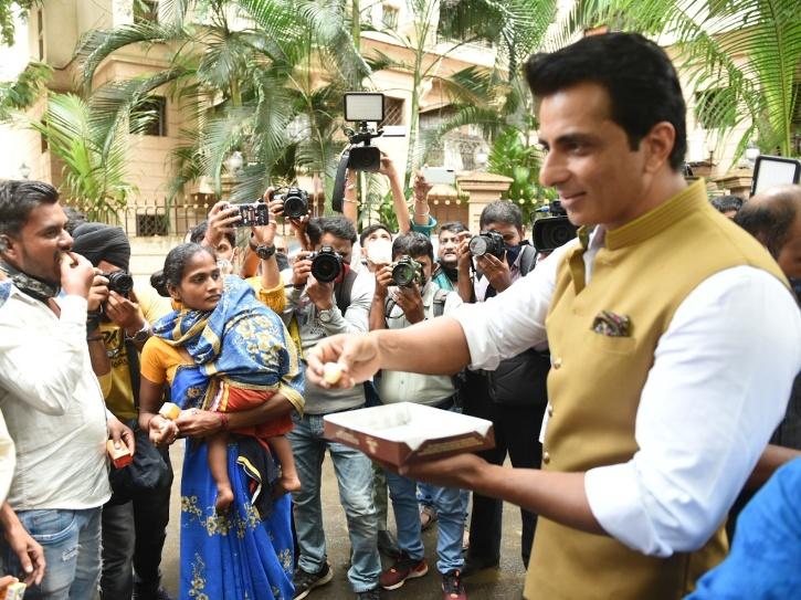 Sonu Sood distributes sweets to fans.