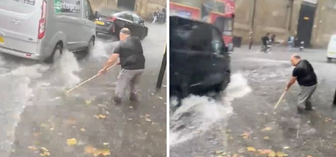 Man Tries To Clear Water Using Broom After Heavy Flooding In London
