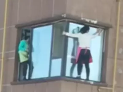 Women Clean Windows Without Safety Gear