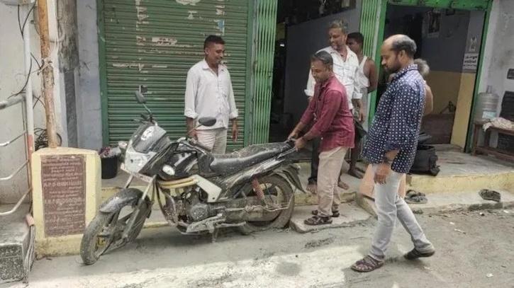 Concrete was laid without removing the bike parked on the road