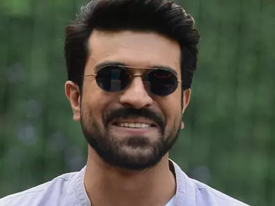 A smiling photo of RRR actor Ram Charan.