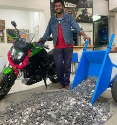 tamil nadu youth buys dream bike with coins he saved in three years