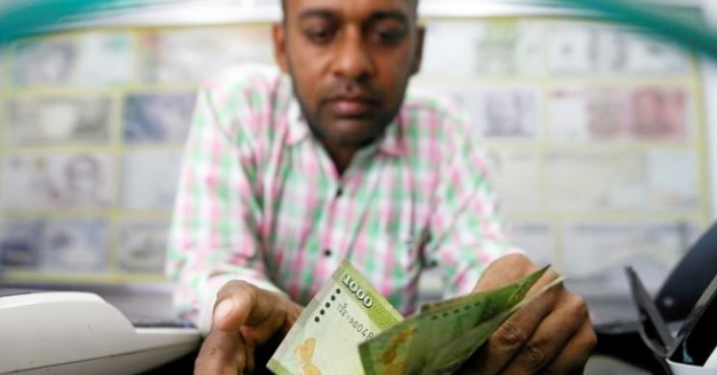 Sri Lanka devalues rupee, seen as step towards getting IMF help