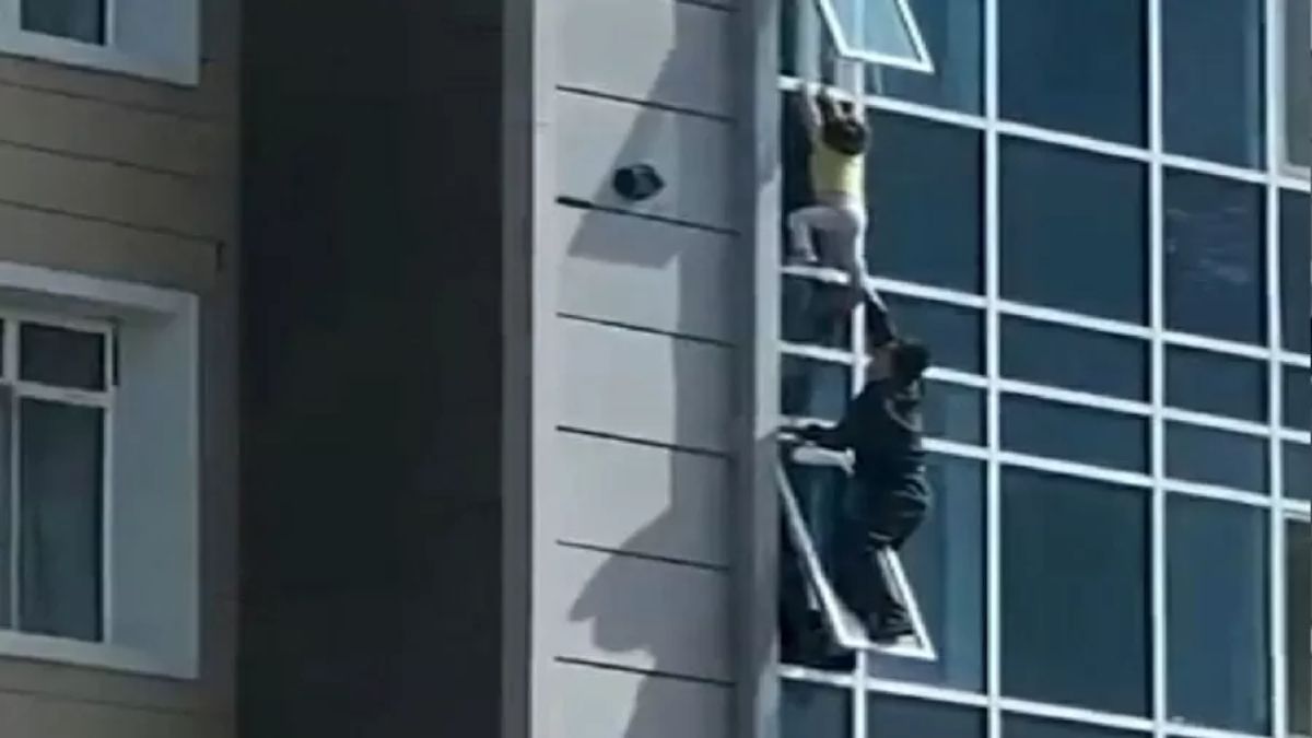 Watch: Man climbs out of window to rescue toddler hanging from 8th floor in  Kazakhstan