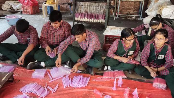 blind children are making candles with their own hands