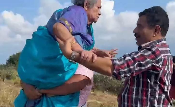 two sons carry mother on shoulder to fulfill her dream of watching neelkurinji 