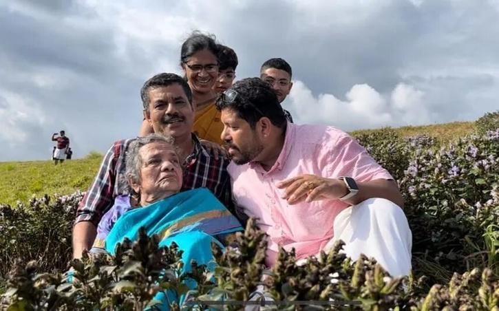 two sons carry mother on shoulder to fulfill her dream of watching neelkurinji 