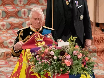 King Charles III placed a royal flag on the former monarch's coffin during the ceremony.