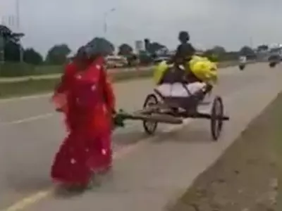 woman-pulls-a-cart-alone-on-road-632c4e688b5bb