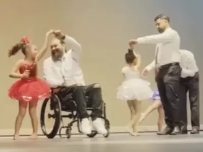 Dad On Wheelchair Dances With Daughter
