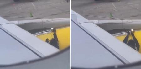 Airline Worker Tapes Plane Wing Before Takeoff