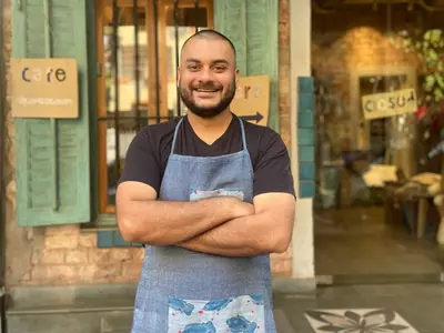 Thirty-four-year-old Auroni Mookerjee, who helms the kitchen at Kolkata’s eclectic Sienna Café, recalls a rather specific inspiration for his pop-up favourite, bhaat’er golla. It is a ball of rice, with a hidden, flavour-packed stuffing, often neem-begun 