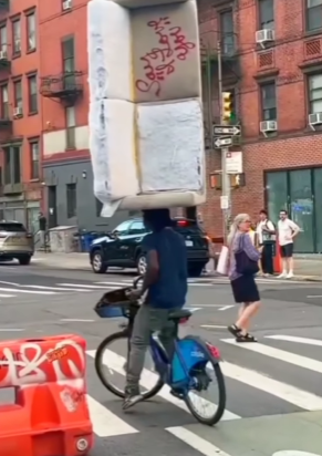 New York Cyclist Balances Couch on Head 