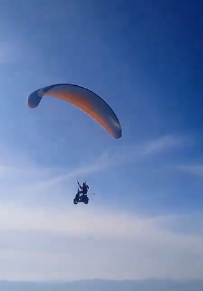 An electric scooter paraglider takes to the skies with a Punjabi Daredevil