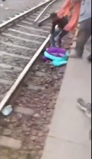 The train passes over a woman from Bihar and her two children, causing them to miraculously escape