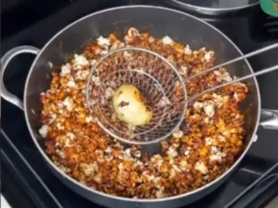 Woman places egg in a popcorn