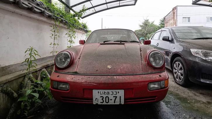 Man explores abandoned car in Fukushima