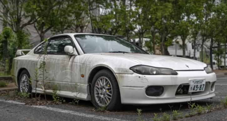 Man explores abandoned car in Fukushima