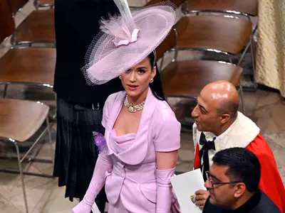 Katy Perry in Lilac dress and hat trying to find her seat at King Charles III's coronation
