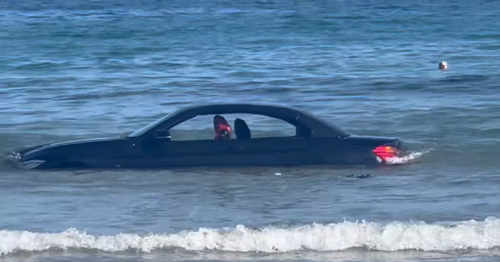 BMW parked on the beach 